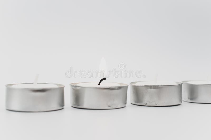 Burning Pure Wax Scented Tea Lights on a White Background with Space