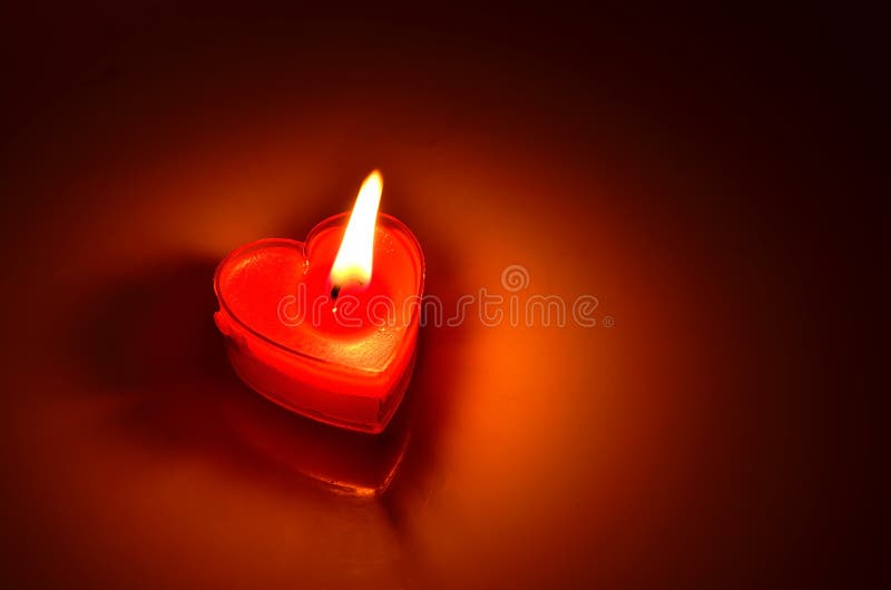 Burning red candle heart