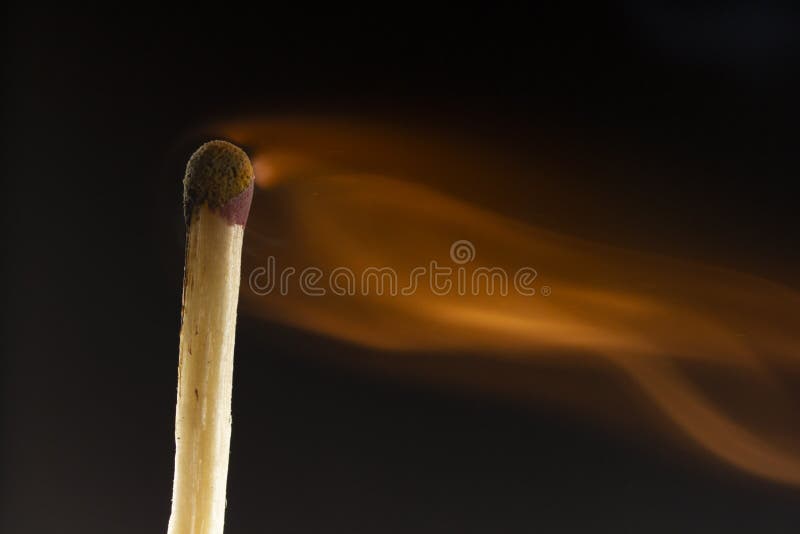 Burning Wooden Match with a Red Match Head on a Black Background Stock