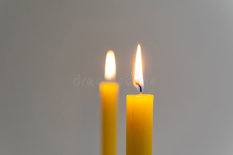 Burning yellow candles stock image. Image of candle 138142575