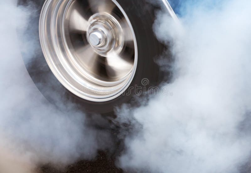 A car doing a burnout so that the tires spin smoke and smell of rubber. A car doing a burnout so that the tires spin smoke and smell of rubber.