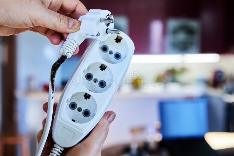 Extension cord damage is caused short circuits after overloading, burnt power cable causes fire. Damaged extension cord stock images, royalty-free photos and pictures