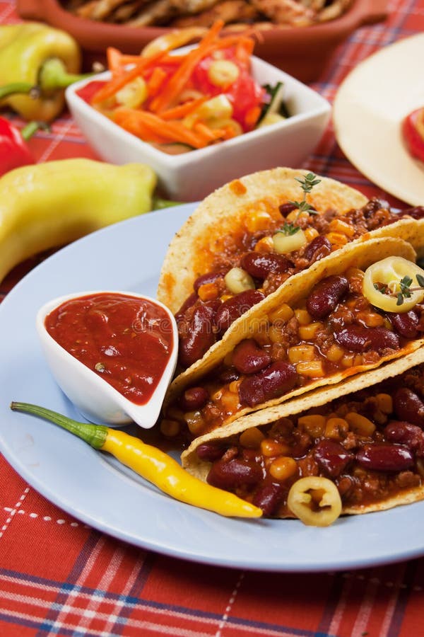 Chili con carne burritos in corn taco shells. Chili con carne burritos in corn taco shells