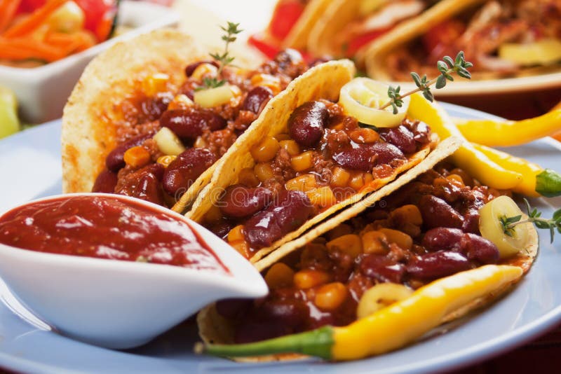 Chili con carne burritos in corn taco shells. Chili con carne burritos in corn taco shells