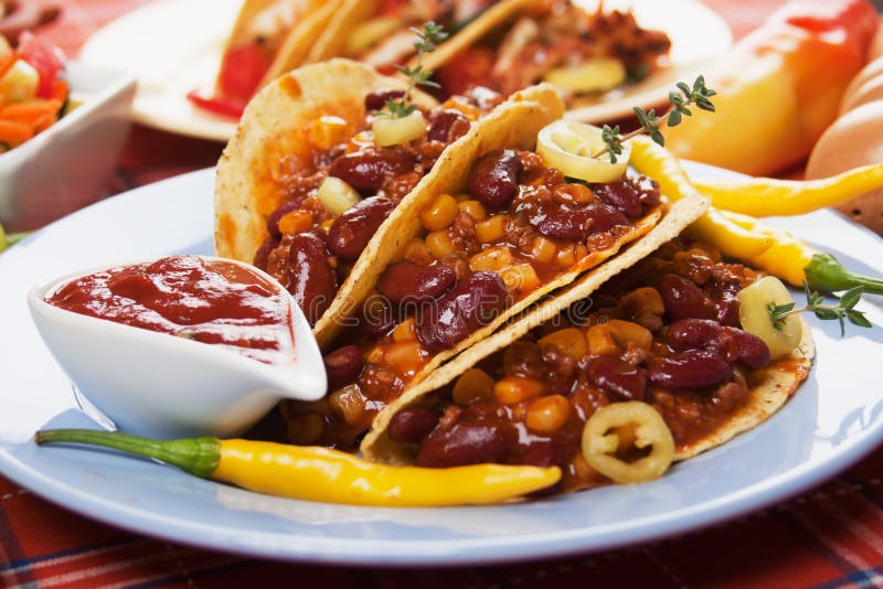 Chili con carne burritos in corn taco shells. Chili con carne burritos in corn taco shells