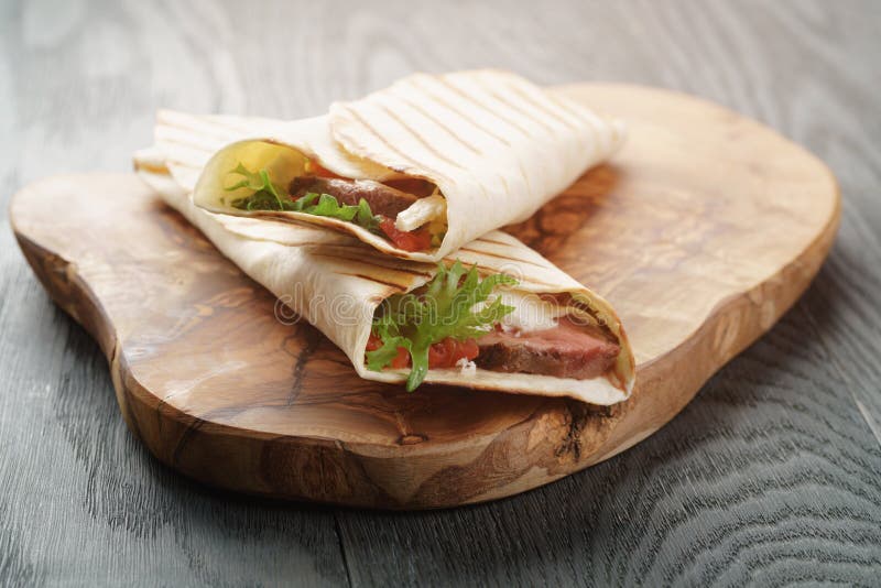 Burritos with Beef Steak, Corn, Black Beans on Wood Table Stock Image
