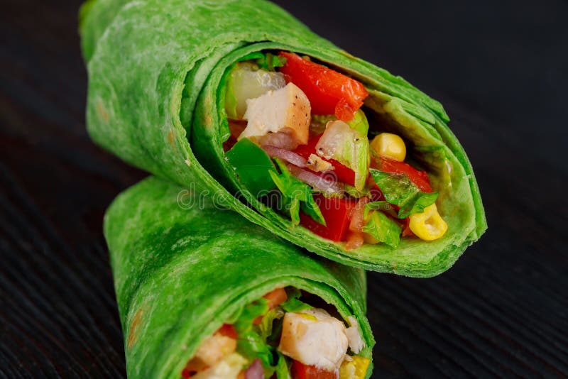 Burritos wraps with beef and vegetables on black background. Beef burrito, mexican food stock photography Burritos wraps with beef and vegetables on black background. Beef burrito, mexican food stock photography