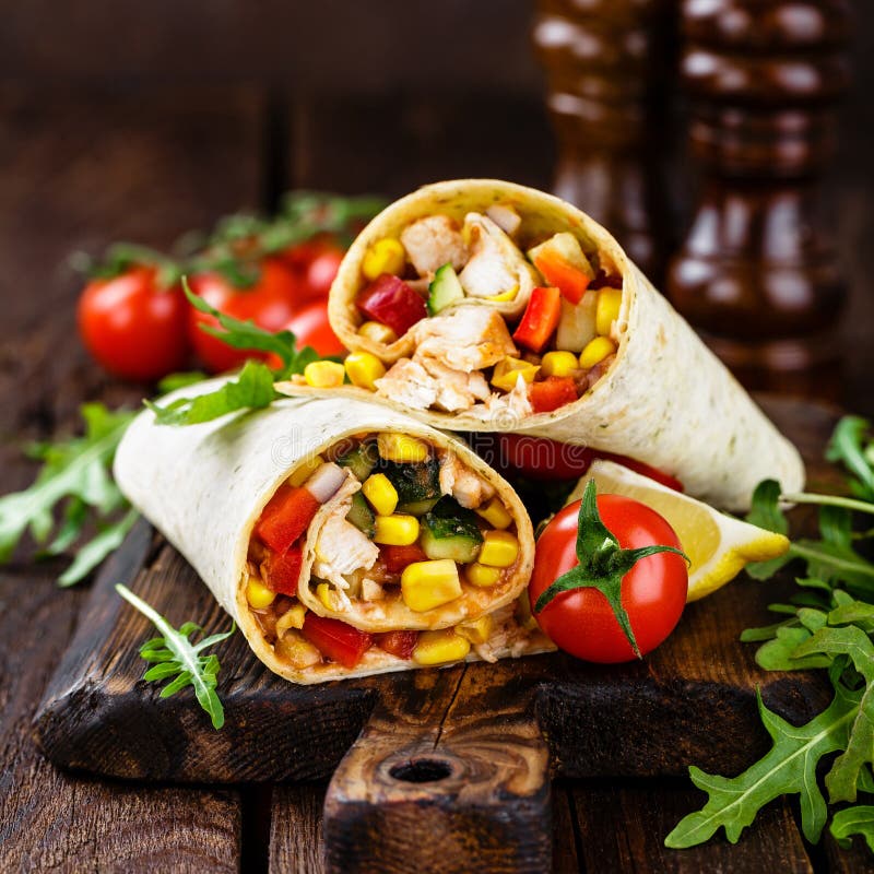 Burritos Wraps with Chicken Meat and Vegetables on Wooden Background