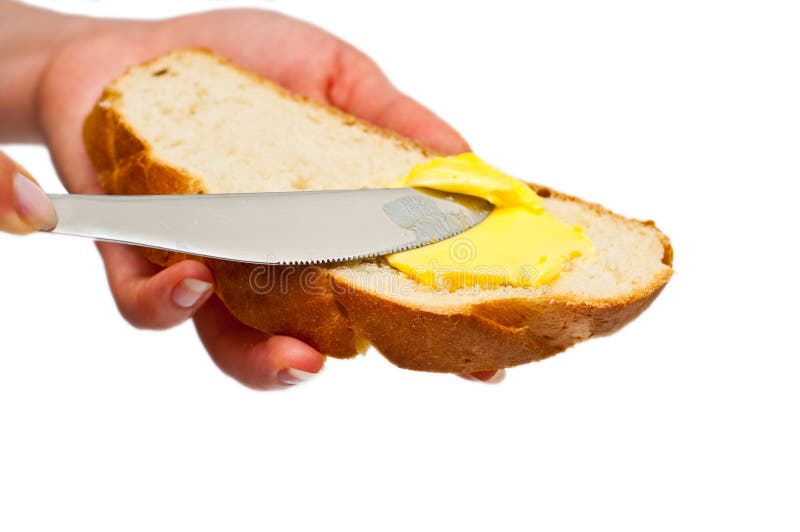 Burro di diffusione della donna su pane isolato immagini stock libere da diritti Burro di diffusione della donna su pane isolato immagini stock libere da diritti