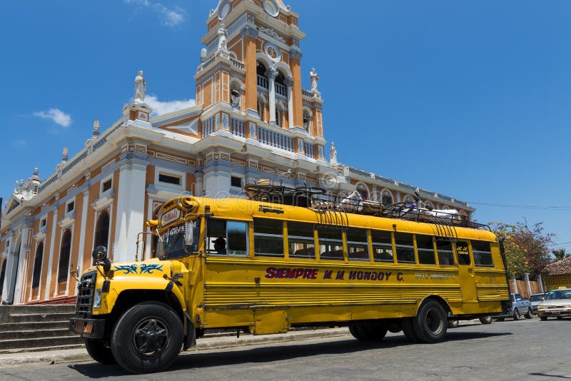 Bus in front of a Church in a street of the colonial city of Granada, in Nicaragua