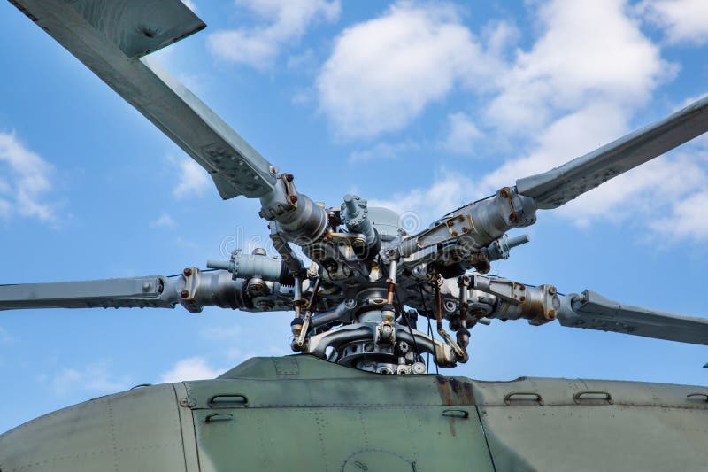 Bushings and automatic-skew helicopter gray against the background of clouds on a clear sunny day Military equipment atom planes missiles helicopters.