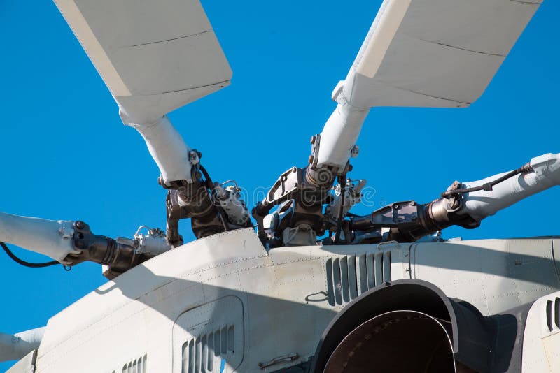 Bushings and automatic-skew helicopter silver color against a blue sky on a clear sunny day Military equipment atom planes missiles helicopters.