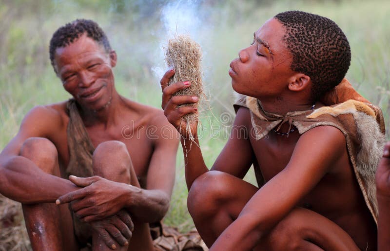 Men of the Bushmen tribe making fire in Kalahari Desert, Botswana. Men of the Bushmen tribe making fire in Kalahari Desert, Botswana.