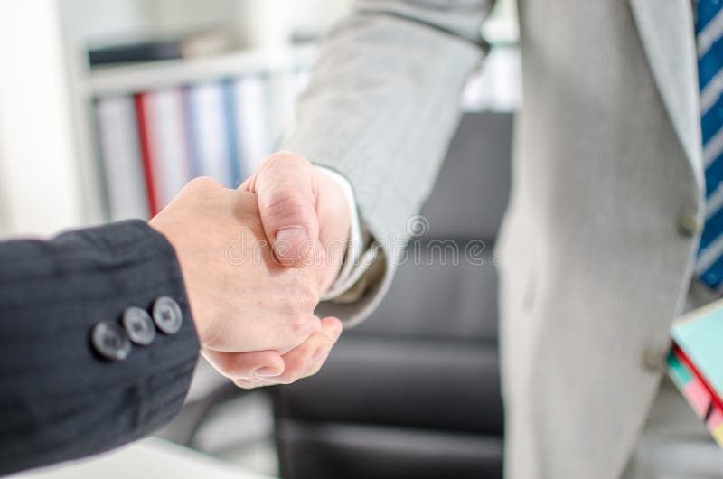 Business associates shaking hands at office stock images Business associates shaking hands at office stock images