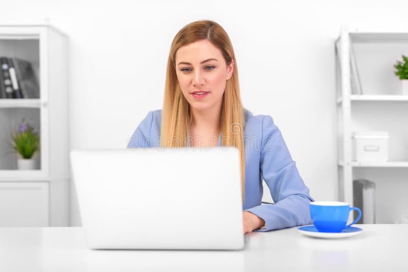Business attractive woman working on laptop at workplace or at home. royalty free stock images Business attractive woman working on laptop at workplace or at home. royalty free stock images
