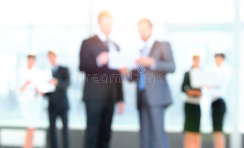 Business background.blurred image of business people standing in office.