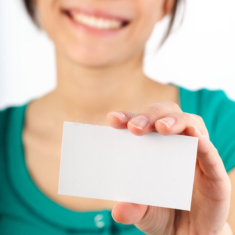 Beautiful young woman with big smile displaying blank business card. Shallow depth of field, focus on card. Isolated on white.