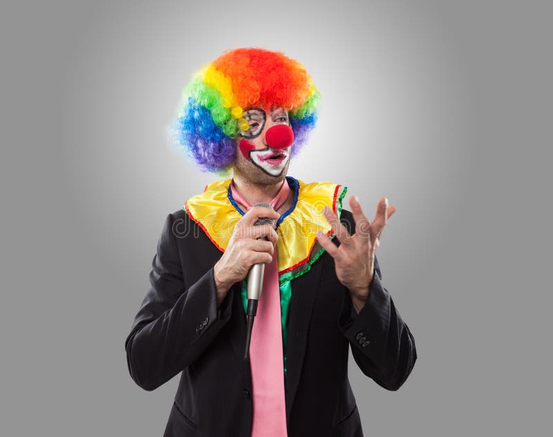 Business clown talking with a microphone stock images Business clown talking with a microphone stock images