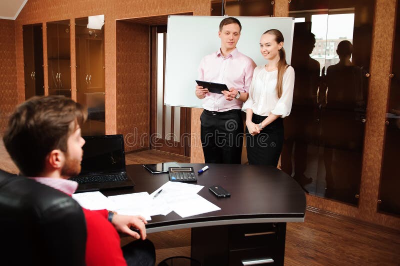 Business coach holding training for staff in the office.