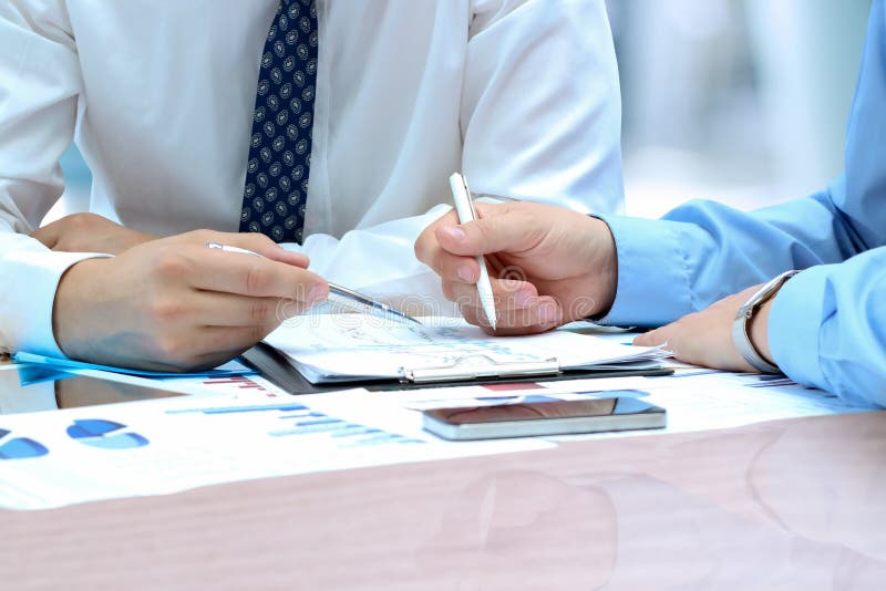 Business colleagues working and analyzing financial figures on a graphs royalty free stock image Business colleagues working and analyzing financial figures on a graphs royalty free stock image