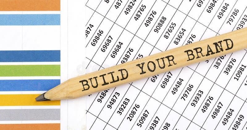 Business concept BUILD YOUR BRAND text on the pencil on chart background royalty free stock images