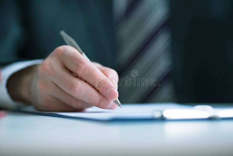 Business concept: businessman signs a contract