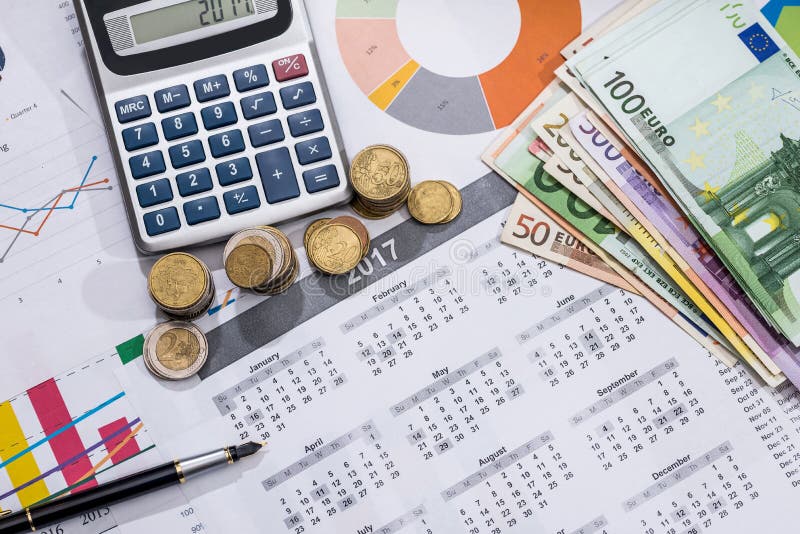 Euros bills, calendar, pen and calculator.