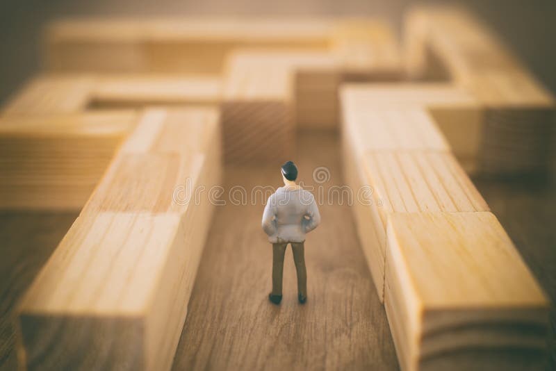 Business concept image of and challenge. A man stands in the maze looking for the exit. Problem solving and decision making idea stock images Business concept image of and challenge. A man stands in the maze looking for the exit. Problem solving and decision making idea stock images