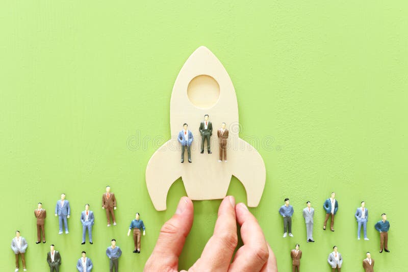 Business concept of leadership and teamwork. A group of people on a rocket gain an advantage over the others royalty free stock images