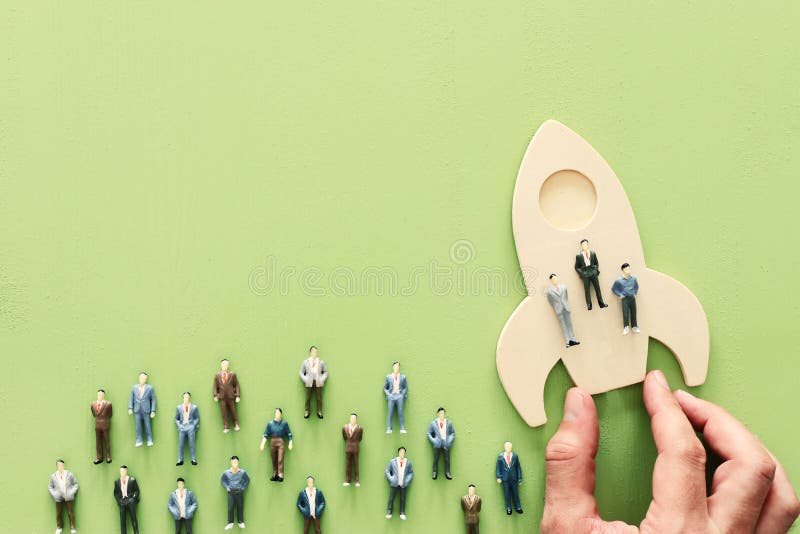 Business concept of leadership and teamwork. A group of people on a rocket gain an advantage over the others royalty free stock photos