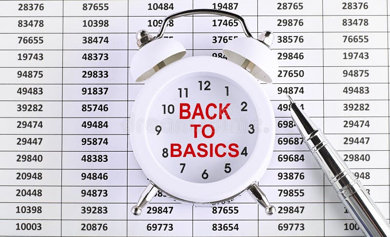 Business concept. text BACK TO BASIC on alarm clock on chart background stock photo