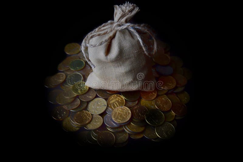 The business concept of time is a bag of Russian coins on a pile of coins on a dark background. close-up and soft focus.