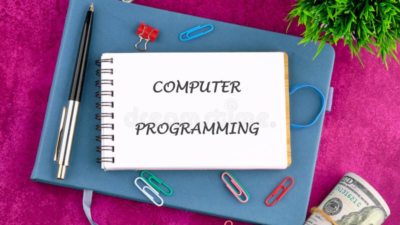 Business concept. Words COMPUTER PROGRAMMING in a mini notebook on a business book, top view. Copy space stock photo