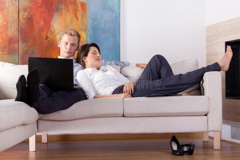 Business couple resting at home royalty free stock photo