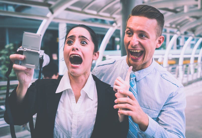Business couple taking funny crazy selfie with camera stock photo
