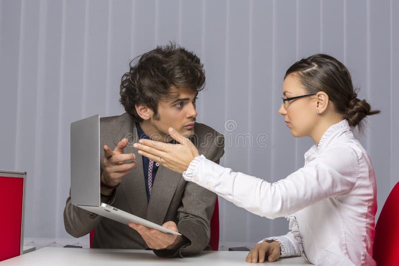 Two irritated business partners arguing and gesturing while trying to solve business problems at work. Two irritated business partners arguing and gesturing while trying to solve business problems at work.