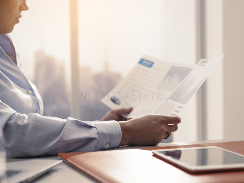 Business executive checking financial reports in the office stock images Business executive checking financial reports in the office stock images