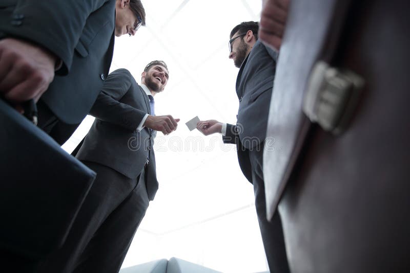 Closeup of businesspeople exchanging business card Stock Photo by BGStock72