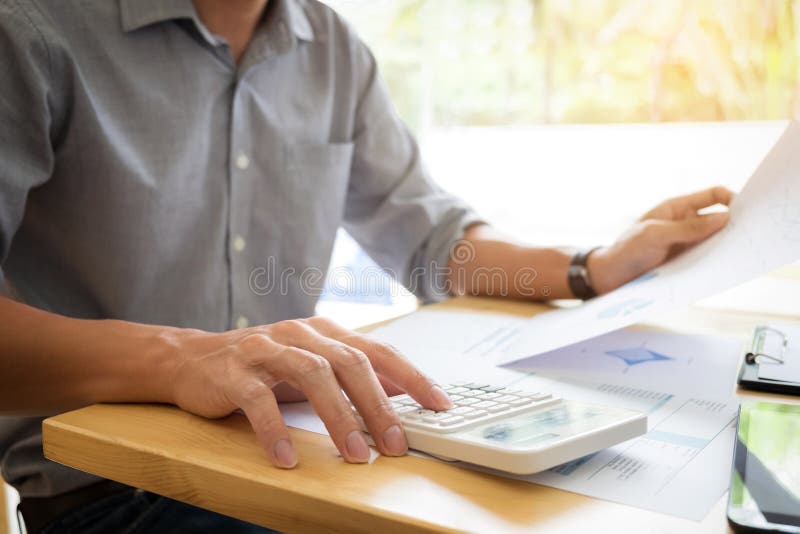 Business executives hands using calculator to calculate tax Invoice and set new project business strategy plan with data document royalty free stock photography Business executives hands using calculator to calculate tax Invoice and set new project business strategy plan with data document royalty free stock photography