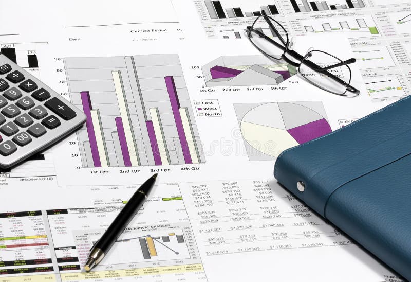 business financial chart analysis with pen, eyeglasses, calculat