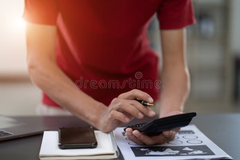 Business and financial concepts about office work. Analysts discuss business with a calculator as a tool.