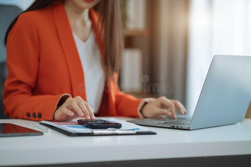 Business and financial concepts about office work. Analysts discuss business with a calculator as a tool.