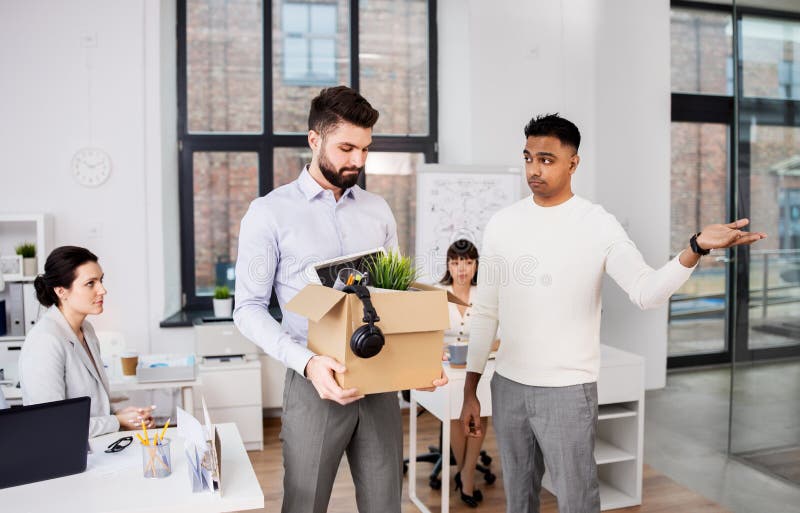 Executive seeing off sad fired male office worker stock photography Executive seeing off sad fired male office worker stock photography