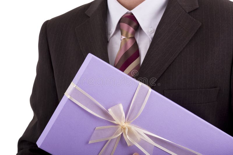 Businessman holding a gift or box of chocolates. Male hand holding businessman stock images, royalty-free photos and pictures