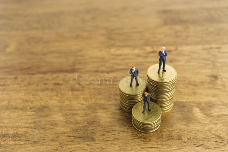 Business growth and investment level up concept. a little figure miniature businessman stand on stacks of coins royalty free stock photography Business growth and investment level up concept. a little figure miniature businessman stand on stacks of coins royalty free stock photography