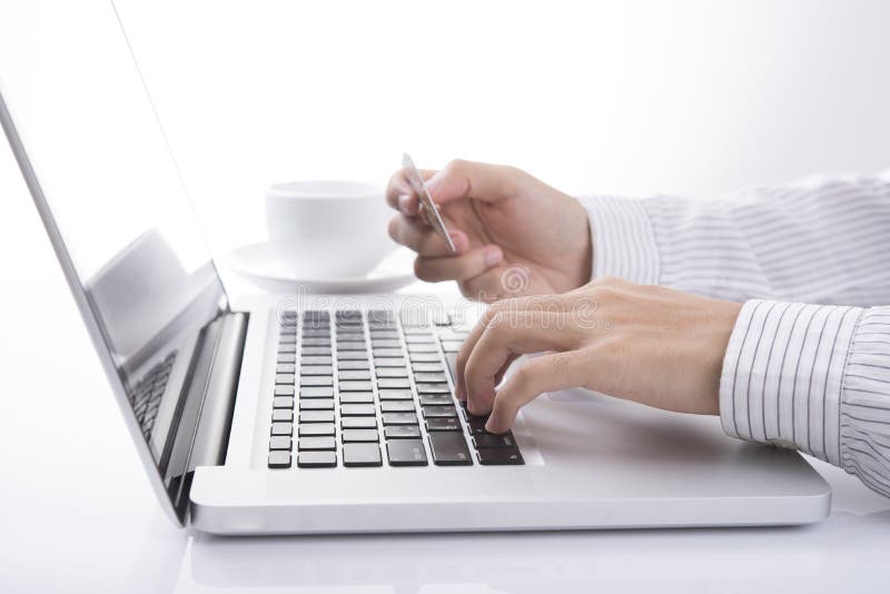 Business hand holding credit card with computer and shopping royalty free stock photos