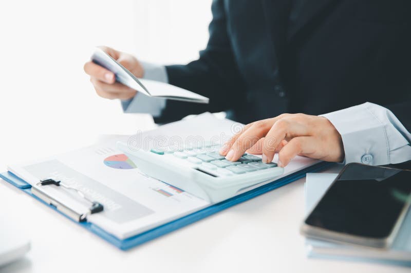Business hands holding saving account passbook with calculator, account and saving concept. finance effectively, calculate income