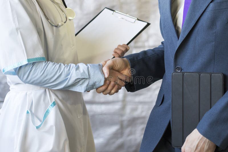 Business handshake. Businessman shaking hands with doctor shaking hands.