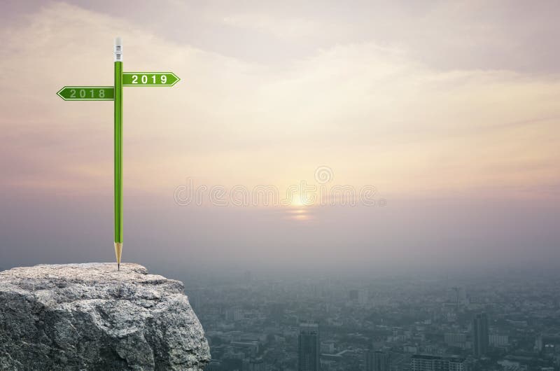 Business happy new year 2019 planning concept. 2019 and 2018 direction sign plate with green pencil on rock over aerial view of cityscape at sunset, vintage stock photo