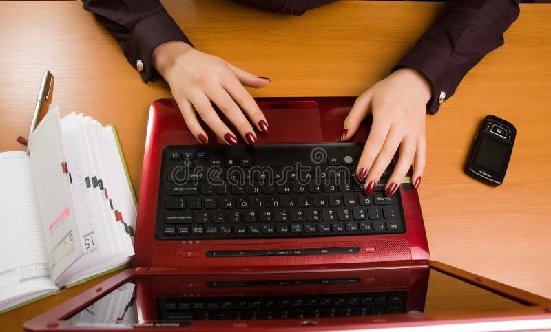 Business lady at desk writing.